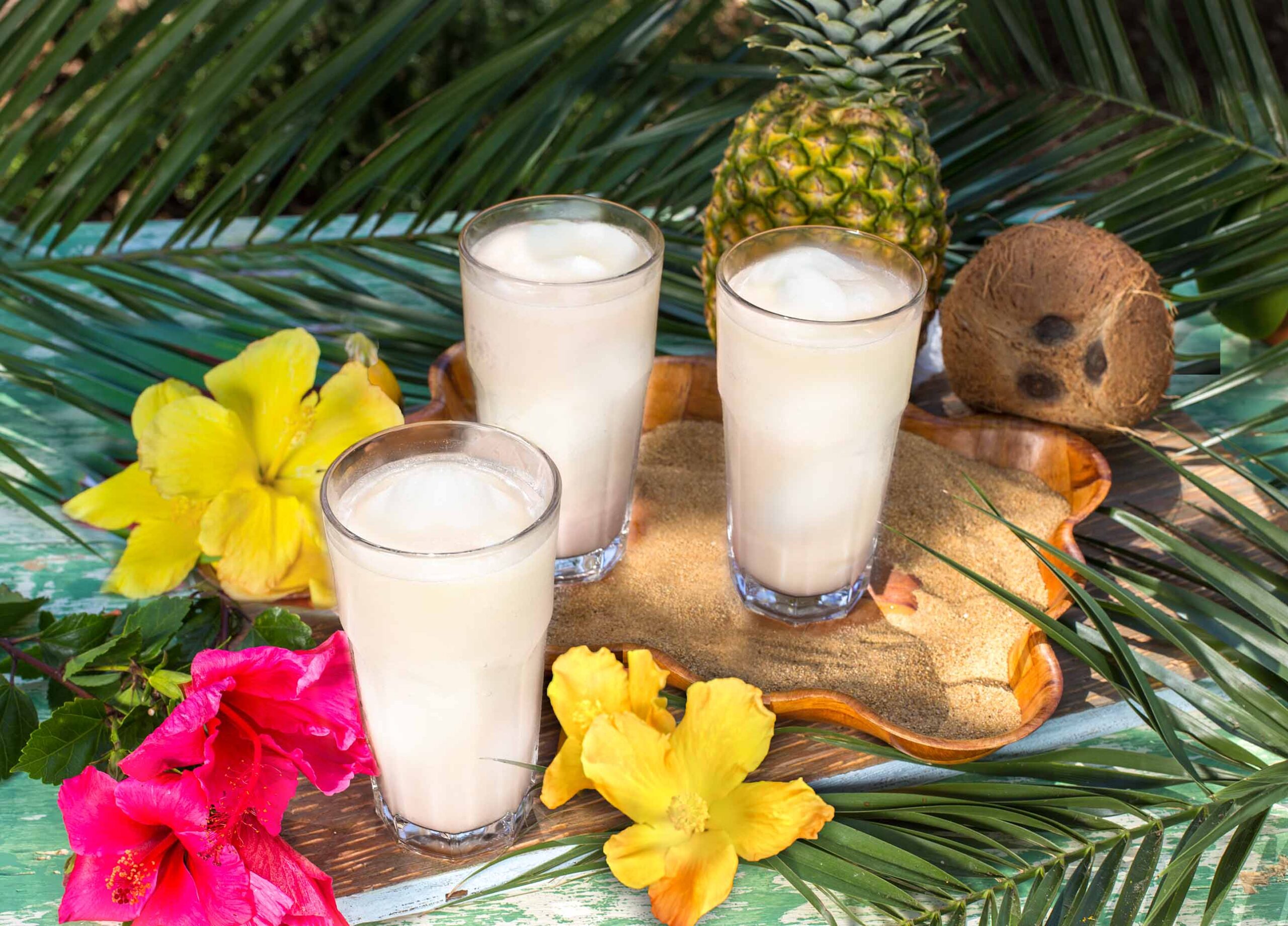 Three of our new monthly special Swirl drinks at our patio with a tropical table setting