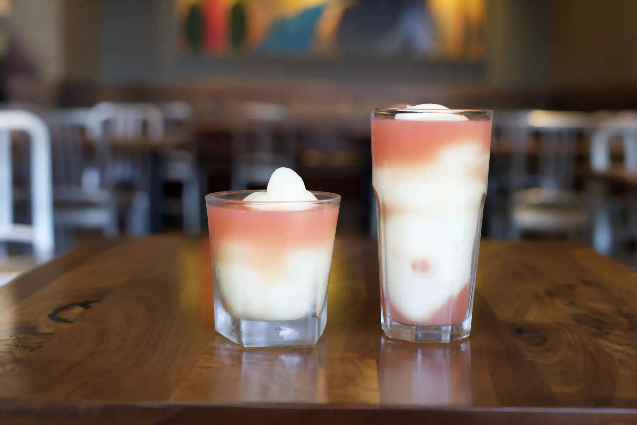 Two glasses of layered pink and white margarita Swirls
